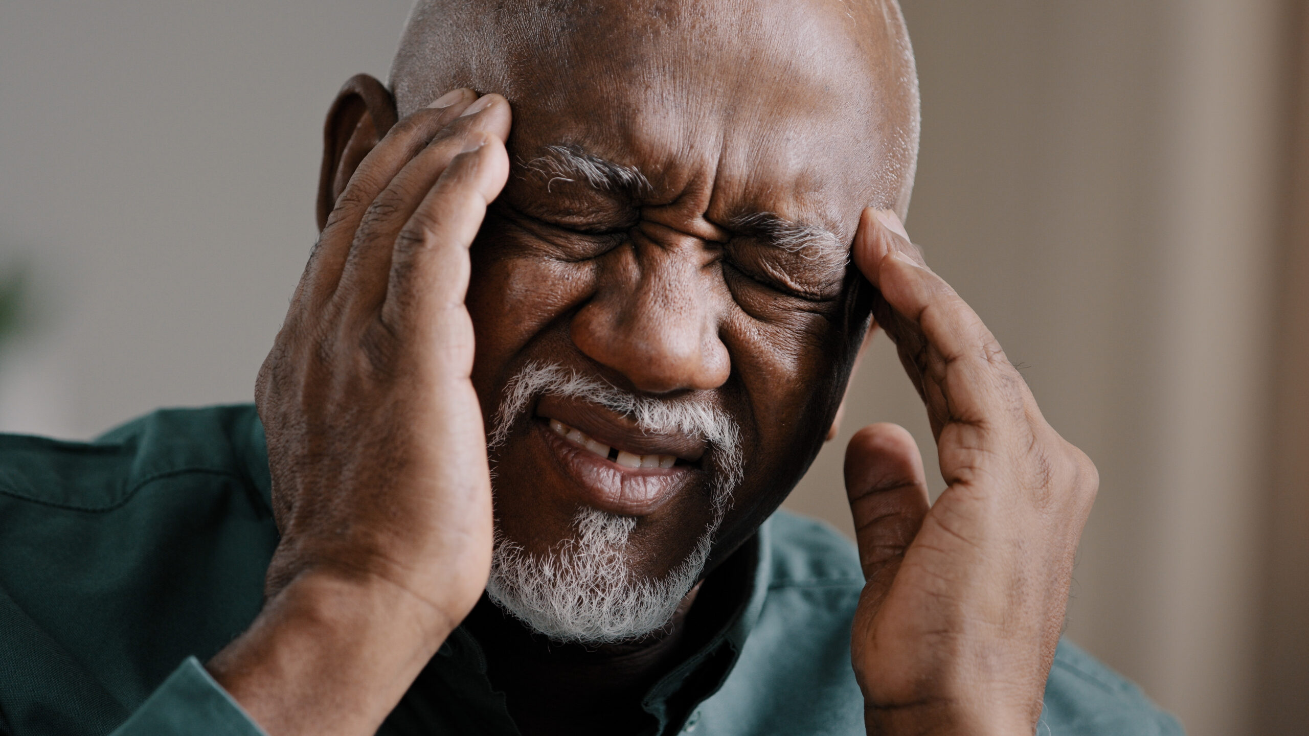 A man with his hands on his head.